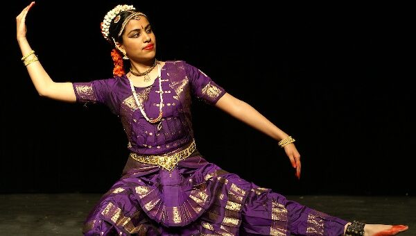 An Image of a girl performing a sitting pose in Bharatnatyam