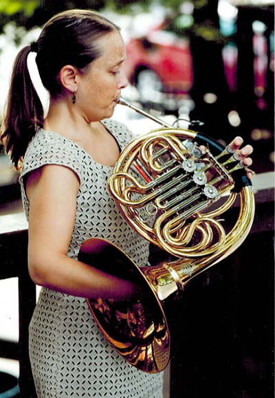 A woman playing the horn